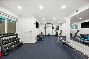 Workout room with crown molding and recessed lighting