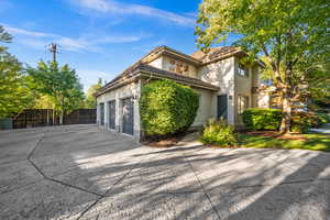 View of home's exterior with driveway, brick siding, and an attached garage