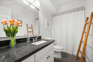 Full bathroom with ornamental molding, a shower with shower curtain, vanity, and dark wood-type flooring
