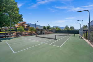 View of tennis court featuring a mountain view