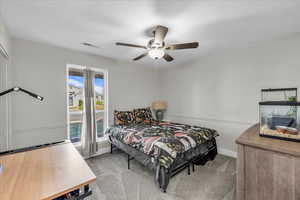 Bedroom featuring light colored carpet and a ceiling fan
