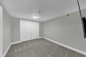 Unfurnished bedroom with a closet and carpet floors