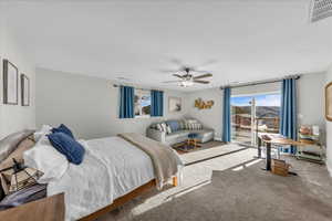 Bedroom featuring carpet, ceiling fan, and access to exterior