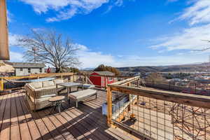 Deck featuring a storage unit and a mountain view
