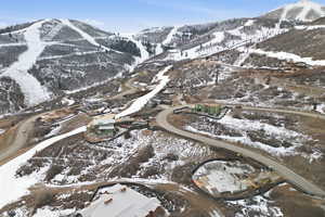Snowy aerial view featuring a mountain view