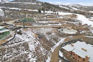 Snowy aerial view featuring a mountain view