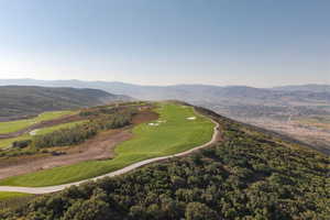 Aerial view of a mountain backdrop and a golf course