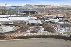 Snowy aerial view with a mountain view and a residential view