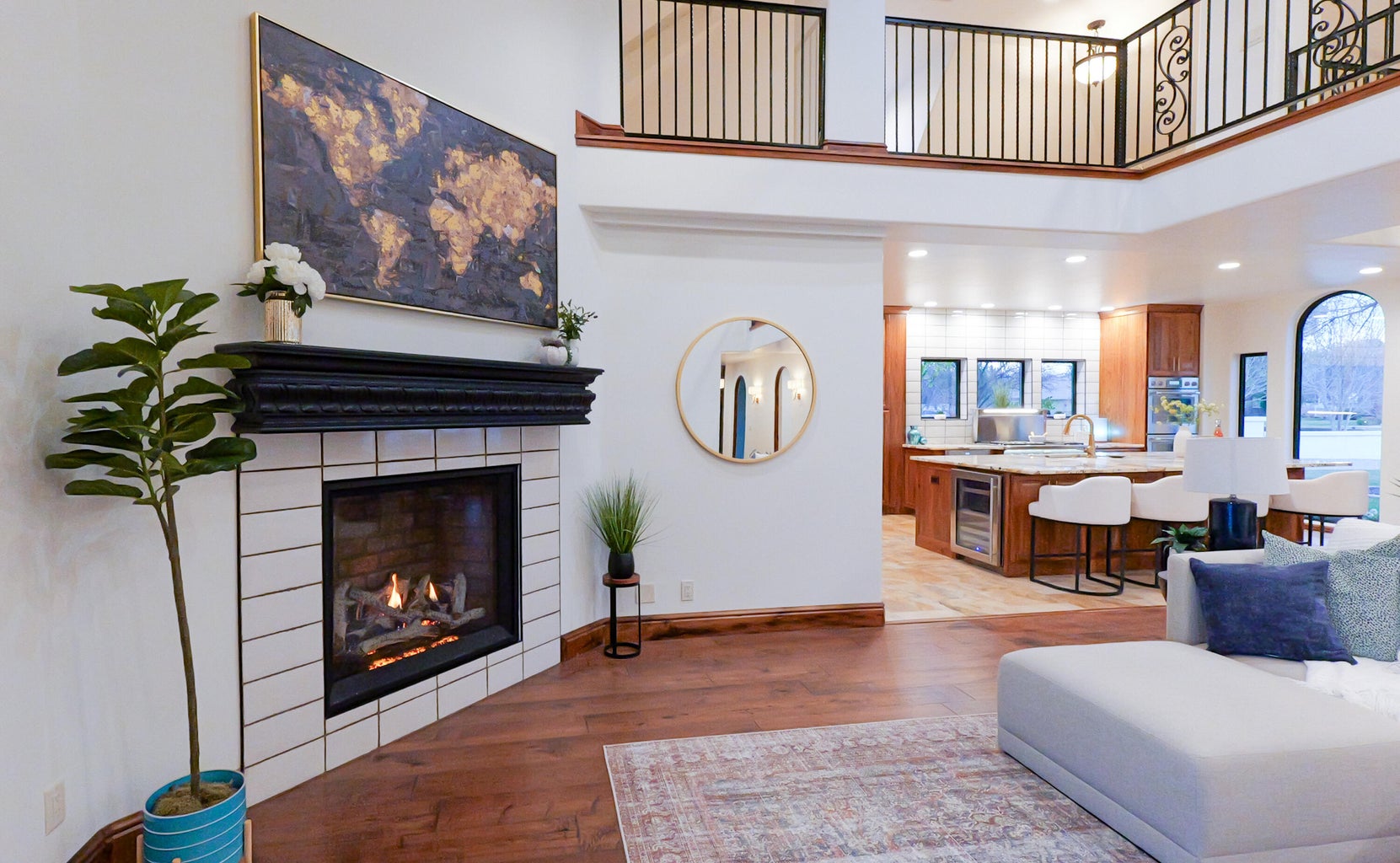 Living area with a tiled fireplace, dark wood-style flooring, recessed lighting, a high ceiling, and wine cooler
