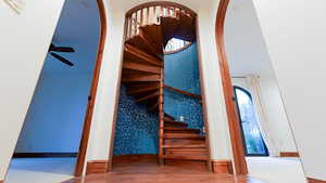 Stairway with arched walkways and wood finished floors
