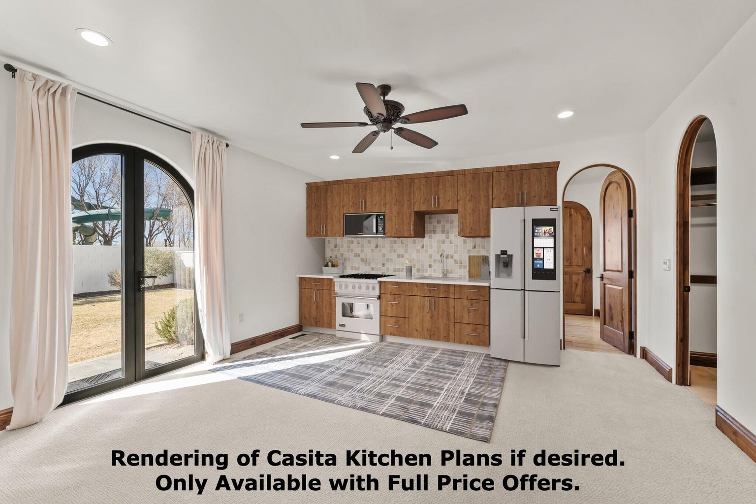 2nd Primary Owner Suite is plumbed for an additional Kitchen with light carpet, arched walkways, white appliances, light countertops, and ceiling fan