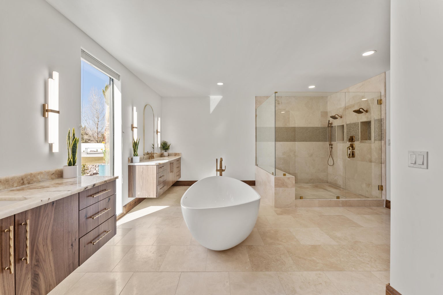 Primary Owner Bathroom featuring a stall shower, two vanities, a soaking tub, and recessed lighting