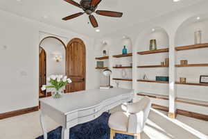 Office area featuring built in shelves, light carpet, ceiling fan, and recessed lighting