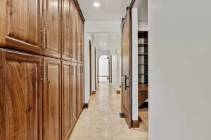 Hall featuring a barn door and tons of cabinets storage space.