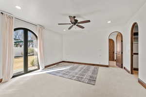 2nd Primary Owner Suite with carpet floors, a ceiling fan, arched walkways, and recessed lighting