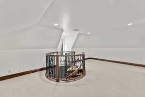 2nd Level Loft area with carpet floors, vaulted ceiling, and recessed lighting