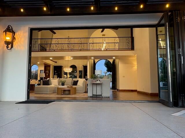 Entrance to property with a patio area and stucco siding