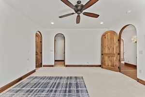2nd Primary Owner Suite  featuring carpet floors, arched walkways, ceiling fan, and recessed lighting