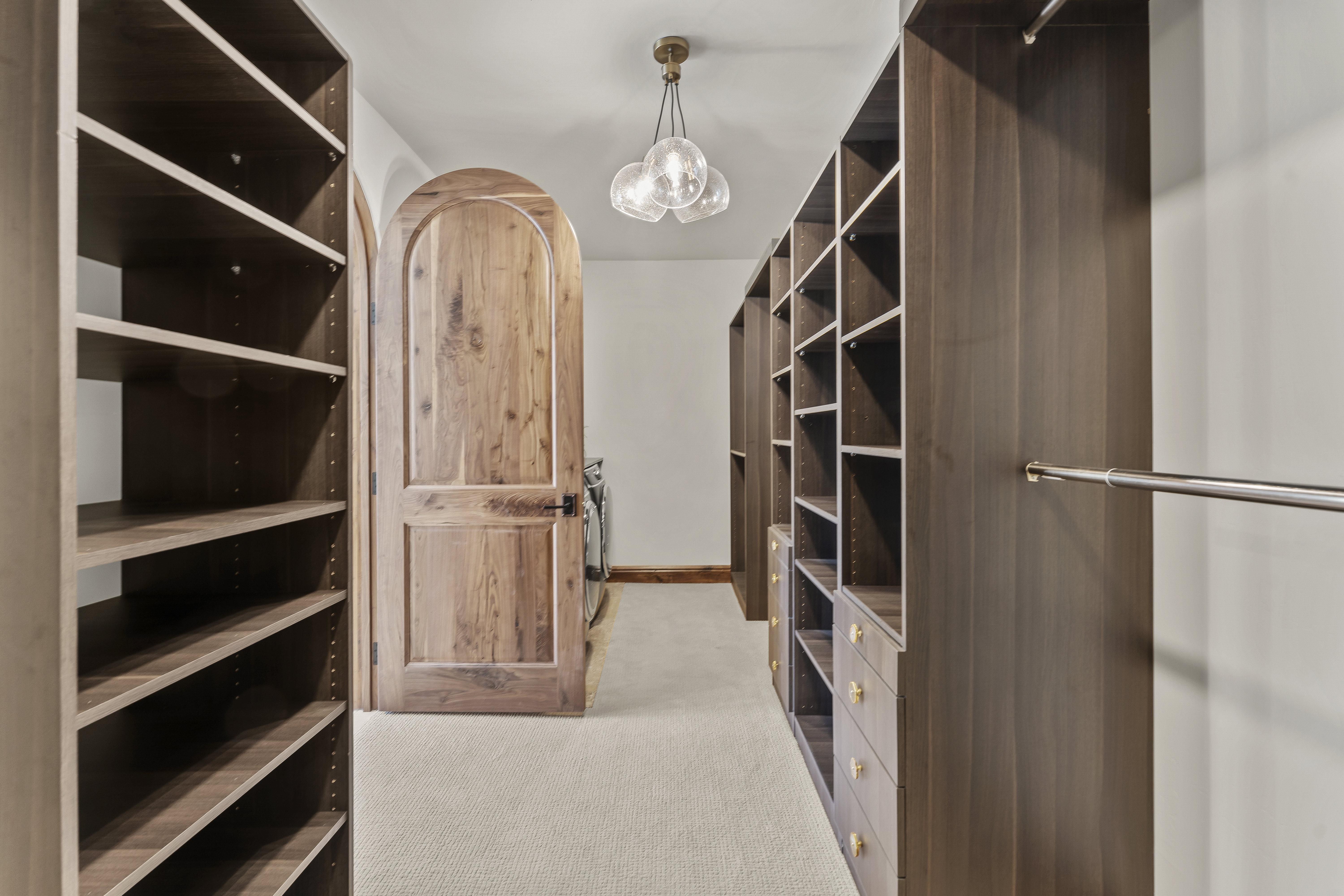 Walk in closet featuring light colored carpet