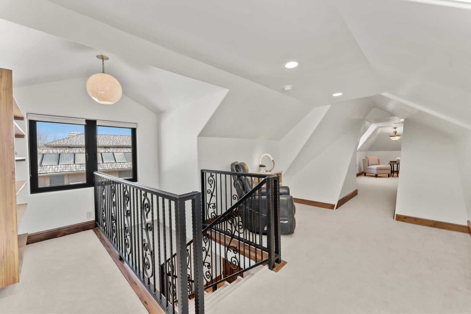 Loft area featuring an upstairs landing, light colored carpet, and recessed lighting