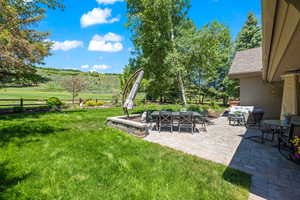 Fenced backyard with a patio and outdoor lounge area