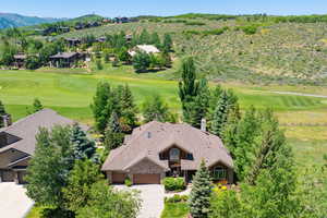 View of subject property featuring a local golf course and a mountainous background