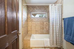 Bathroom featuring shower / tub combo with curtain