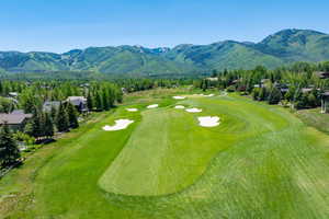 Surrounding community with view of golf course and a mountain view