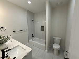 Bathroom featuring double vanity, bathtub / shower combination, and recessed lighting