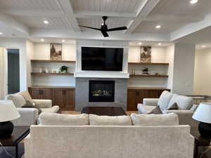 Living area featuring recessed lighting, a fireplace, coffered ceiling, a ceiling fan, and wood ceiling