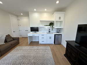 Home office featuring light wood-type flooring and recessed lighting