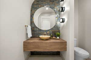 Bathroom with vanity, tile patterned floors, and decorative backsplash