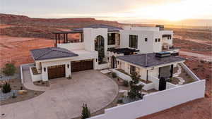 View of front of property featuring stucco siding, driveway, and a mountain view