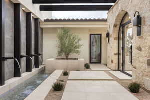 Property entrance featuring stucco siding