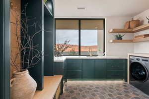 Laundry room with washer / clothes dryer and a sink