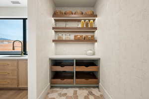 Detailed view of a sink and wood finished floors