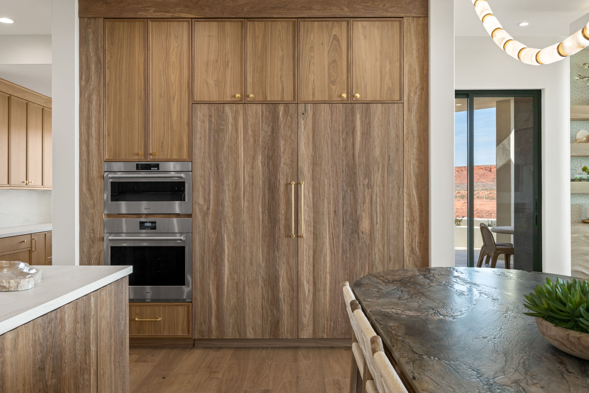 Kitchen with wood finish cabinets, recessed lighting, dark wood-type flooring, stainless steel double oven, and light countertops