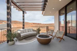 View of patio / terrace featuring a mountain view and an outdoor living space with a fire pit