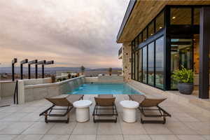 Outdoor pool featuring a patio area and a mountain view