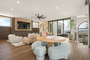 Dining area featuring wood finished floors, a ceiling fan, recessed lighting, and floor to ceiling windows