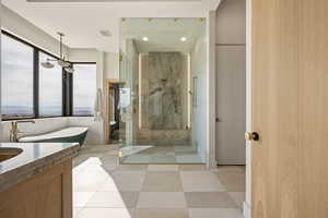 Bathroom featuring a marble finish shower, vanity, recessed lighting, and a freestanding bath