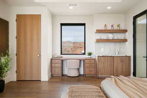 Office space with wood finished floors, recessed lighting, and built in study area