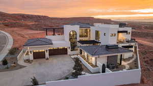 View of front facade with a mountain view, stucco siding, and concrete driveway