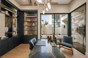Office space with light wood-type flooring and built in features