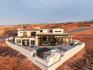 Rear view of house with a patio area, a chimney, a fenced backyard, and a mountain view