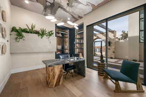 Home office with light wood finished floors