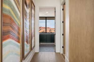 Corridor featuring wood finished floors and recessed lighting