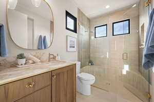 Full bath with a stall shower and vanity