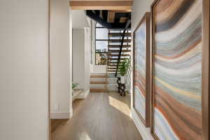 Hall with stairs and light wood finished floors