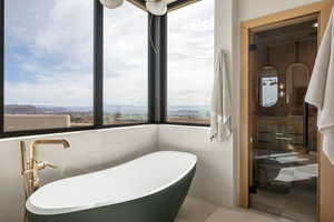 Bathroom featuring a sauna, a freestanding bath, and healthy amount of natural light